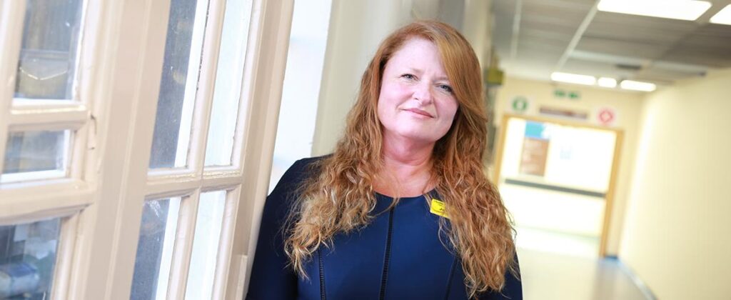 Former Chair Jo Palmer stands in the hospital corridor