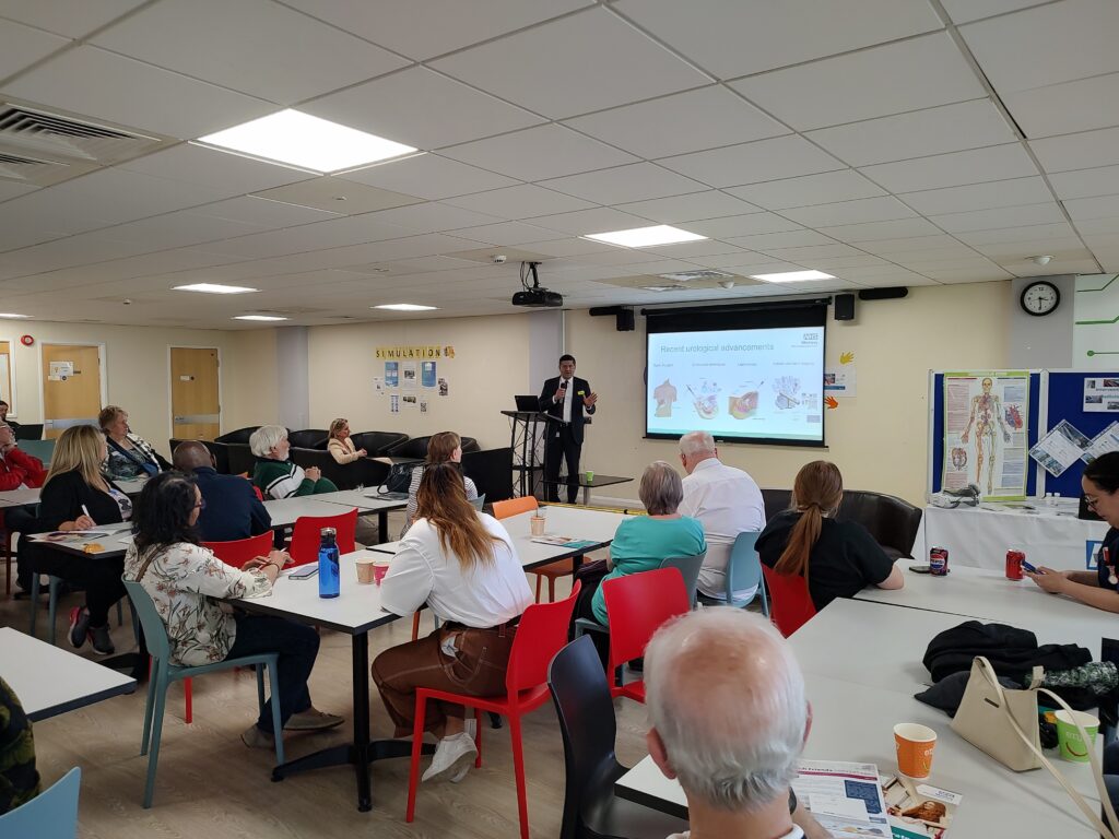 Members of the public listen to a presentation at a hospital event