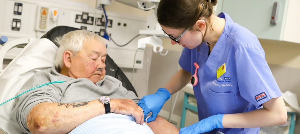 Nurse caring for a patient in bed