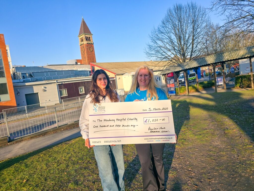 Ruby, League of Friends volunteer with Donna Law, head of Charity handing over money raised