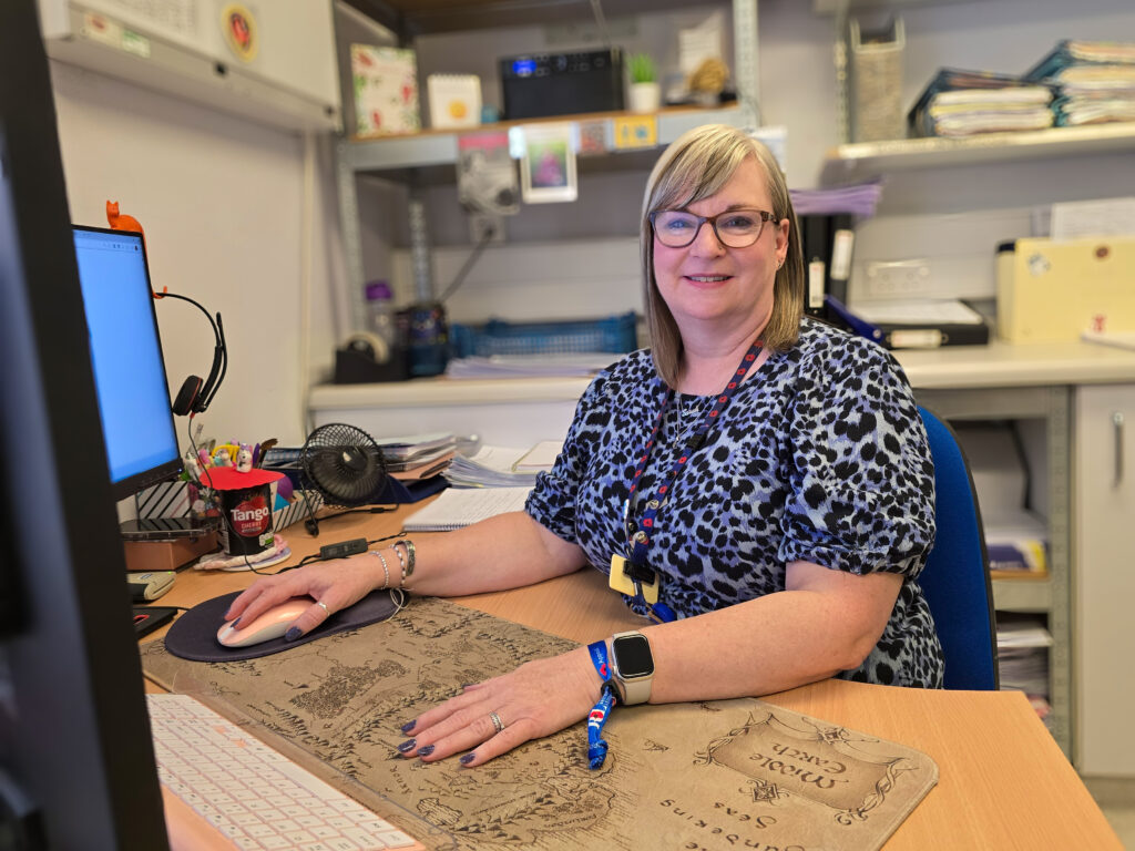 Sarah Bingham smiling at desk